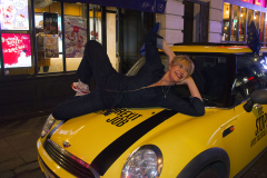 3 Dec 2019 - London, UK - Woman lying on bonnet of mini at Old Compton Street in a stunt organised and crowdfunded by anti-brexit campaigning group EU Flag Mafia.